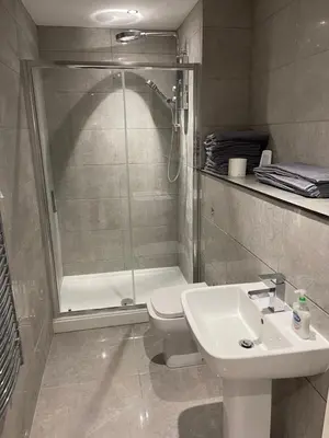 a bathroom with a shower and a toilet and a sink at Lovely, Sleeps 8, Cafe Bars, Central Formby in Formby