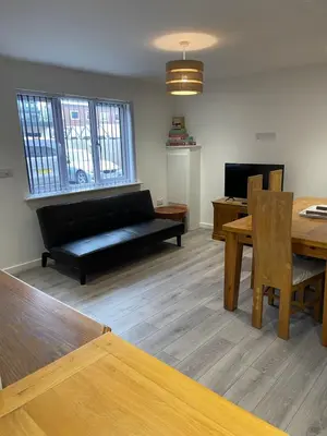 a living room with a couch and a table at Lovely, Sleeps 8, Cafe Bars, Central Formby in Formby