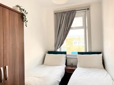 two beds in a room with a window at Spare Property Sasco in Blackpool