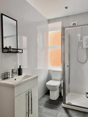 a bathroom with a toilet and a sink and a shower at Spare Property Sasco in Blackpool