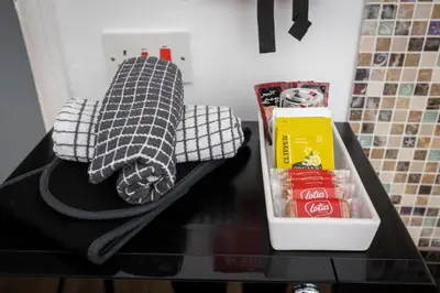 a counter with a bag of food and a box of coke at Charles Alexander Short Stay - Ansdell House in Blackpool