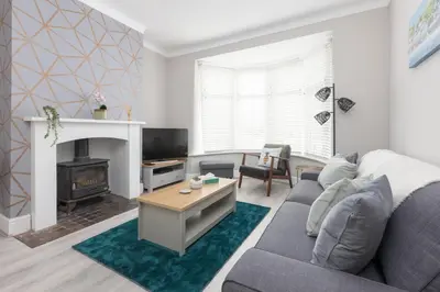 a living room with a couch and a fireplace at Charles Alexander Short Stay - Ansdell House in Blackpool