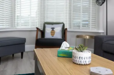 a living room with a table with a plant on it at Charles Alexander Short Stay - Ansdell House in Blackpool