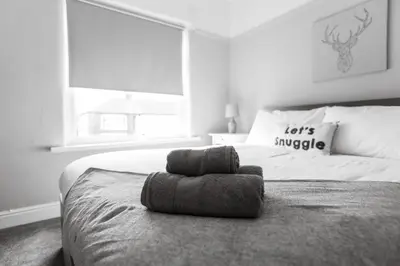 a black and white photo of a bedroom with a bed at Charles Alexander Short Stay - Ansdell House in Blackpool