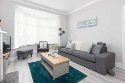 a living room with a couch and a table at Charles Alexander Short Stay - Ansdell House in Blackpool