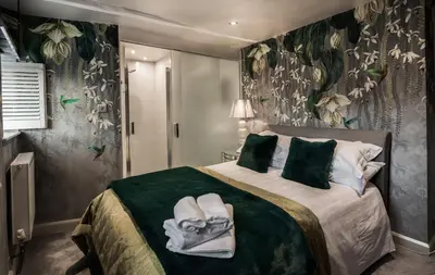 a bedroom with a bed with towels on it at Number 10 in Whalley