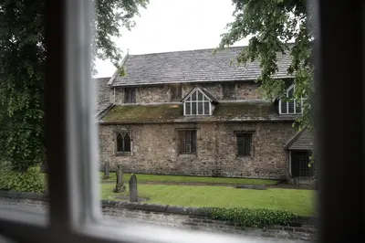 a window view of an old stone building at Number 10 in Whalley