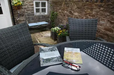 a table with some books and glasses on it at Number 10 in Whalley