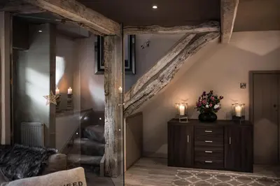 a living room with an attic with a wooden beam at Number 10 in Whalley