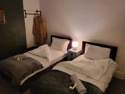 two beds in a room with stuffed animals on them at Jubilee pub in Litherland