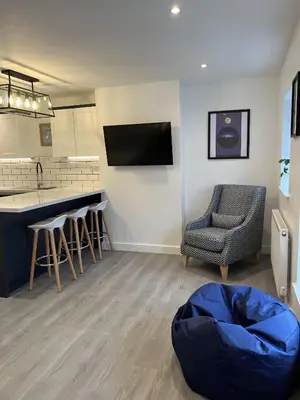 a living room with a kitchen and a bar at 20 Coop Street Apartments in Blackpool