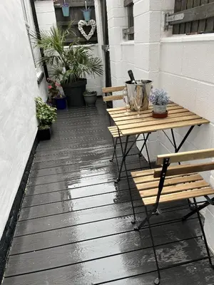 a patio with two benches and a table at 20 Coop Street Apartments in Blackpool