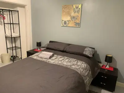 a bedroom with a bed with two night stands and two lamps at Modern 2 bed apartment in Wallasey