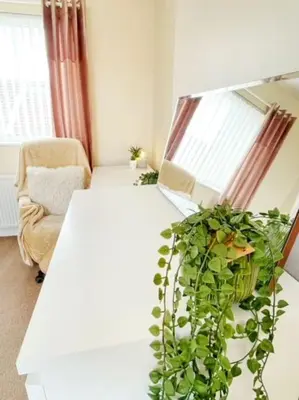 a living room with a white table and a plant at Liverpool Townhouse - 5 bedroom, great transport links in Liverpool