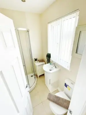 a white bathroom with a toilet and a sink at Liverpool Townhouse - 5 bedroom, great transport links in Liverpool