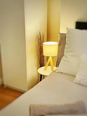 a bedroom with a bed and a table with a lamp at Liverpool Townhouse - 5 bedroom, great transport links in Liverpool