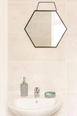 a bathroom with a sink and a mirror at 3-bedroom Home in Liverpool L15 with FREE Parking in Liverpool