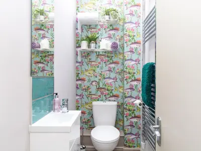 a bathroom with a toilet and floral wallpaper at Methera Cottage - Uk41487 in Spark Bridge
