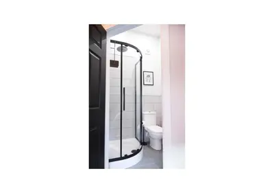 a bathroom with a toilet and a glass shower at Home at 2 Tancred Road Anfield in Liverpool