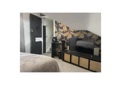 a bedroom with a bed and a flat screen tv at Home at 2 Tancred Road Anfield in Liverpool