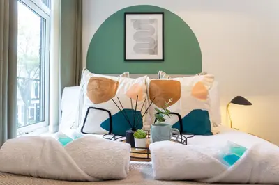 a bed with a bunch of pillows on it at Keith House - Air Host & Stay - Free Parking in Liverpool
