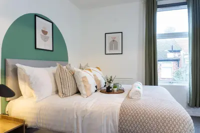 a bedroom with a white bed with a tray on it at Keith House - Air Host & Stay - Free Parking in Liverpool