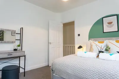 a bedroom with a bed and a desk at Keith House - Air Host & Stay - Free Parking in Liverpool