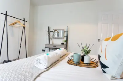a bedroom with a white bed with two pillows at Keith House - Air Host & Stay - Free Parking in Liverpool