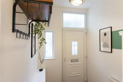 a hallway with a white door and a window at Keith House - Air Host & Stay - Free Parking in Liverpool