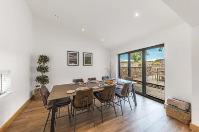 a dining room with a table and chairs at Old Stable in Ulverston