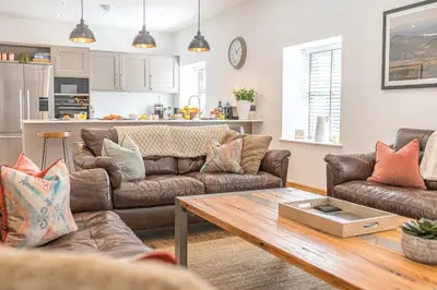 a living room with a couch and a table at Old Stable in Ulverston
