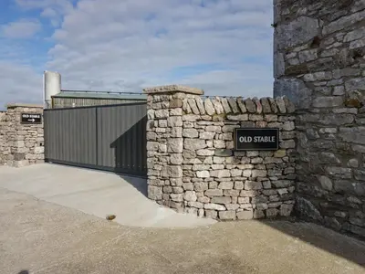 a stone wall with a do not shuttle sign on it at Old Stable in Ulverston