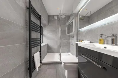 a bathroom with a toilet and a sink and a shower at Old Stable in Ulverston
