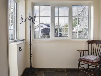 a room with a chair and a window at Guards Cottage in Ulverston