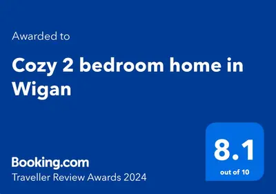 a blue screen with the words cozy bedroom home in wrexham at Cosy 2 Bedroom Home in Wigan in Wigan