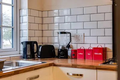 a kitchen counter with a blender on a counter top at Cosy 2 Bedroom Home in Wigan in Wigan