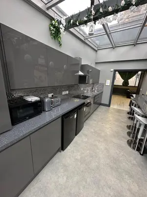 a large kitchen with gray counters and appliances at City CTR Penthouse - rooftop bar, sleeps 19 in Liverpool