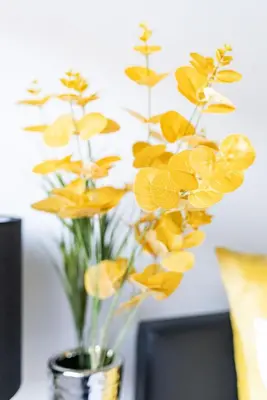 a vase filled with yellow flowers on a table at Warwick West in Barrow in Furness