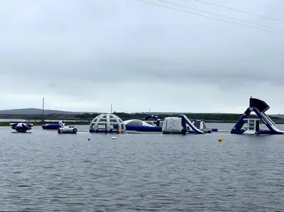 a group of inflatable slides and rides in the water at Lake View Lodge in Millom