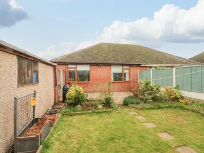 a house with a garden in front of it at Bungalow by the Sea in Cleveleys
