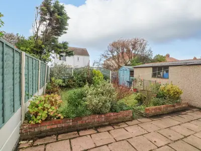 a garden in the back of a house at Bungalow by the Sea in Cleveleys