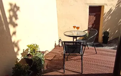 two glasses of wine sitting on a table on a patio at Home from Home near LFC & train station in Liverpool