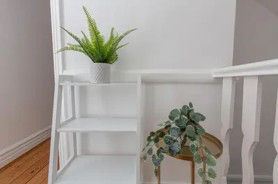 a white shelf with a potted plant on it at Charles Alexander Short Stay - Hove Suite in Lytham St Annes