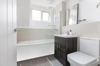 a bathroom with a toilet sink and a shower at Charles Alexander Short Stay - Hove Suite in Lytham St Annes