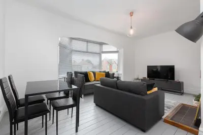 a living room with a couch and a table at Charles Alexander Short Stay - Hove Suite in Lytham St Annes