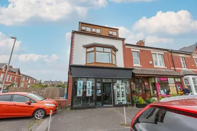 an orange car parked in front of a building at Charles Alexander Short Stay - Hove Suite in Lytham St Annes