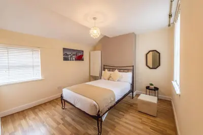 a bedroom with a bed and a window at Holly Room in Liverpool