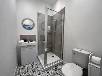 a bathroom with a shower and a toilet and a sink at Monthly Stays Liverpool in Liverpool