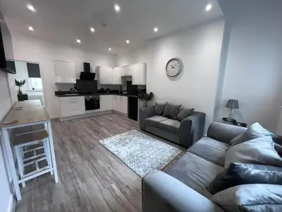 a living room with a couch and a table at Monthly Stays Liverpool in Liverpool