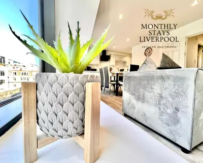 a living room with a potted plant and a couch at Monthly Stays Liverpool in Liverpool